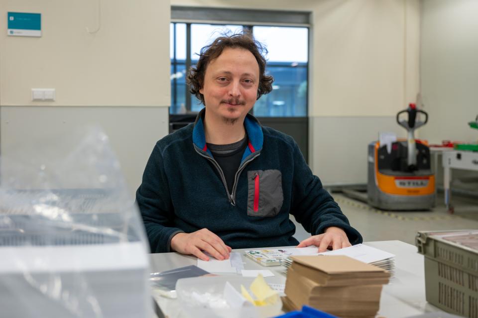 Productiemedewerker pakt wenskaarten in